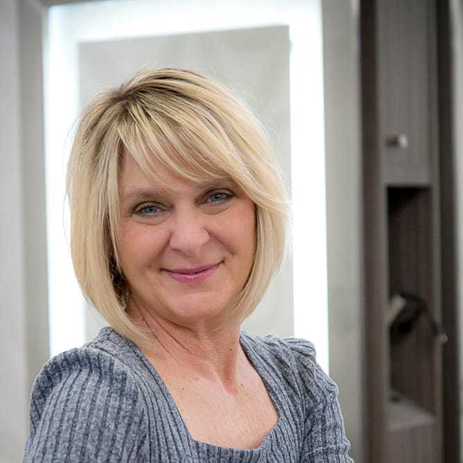 Portrait of Jodi Pliska, a professional stylist at Studio Seven, showcasing their expertise and style.