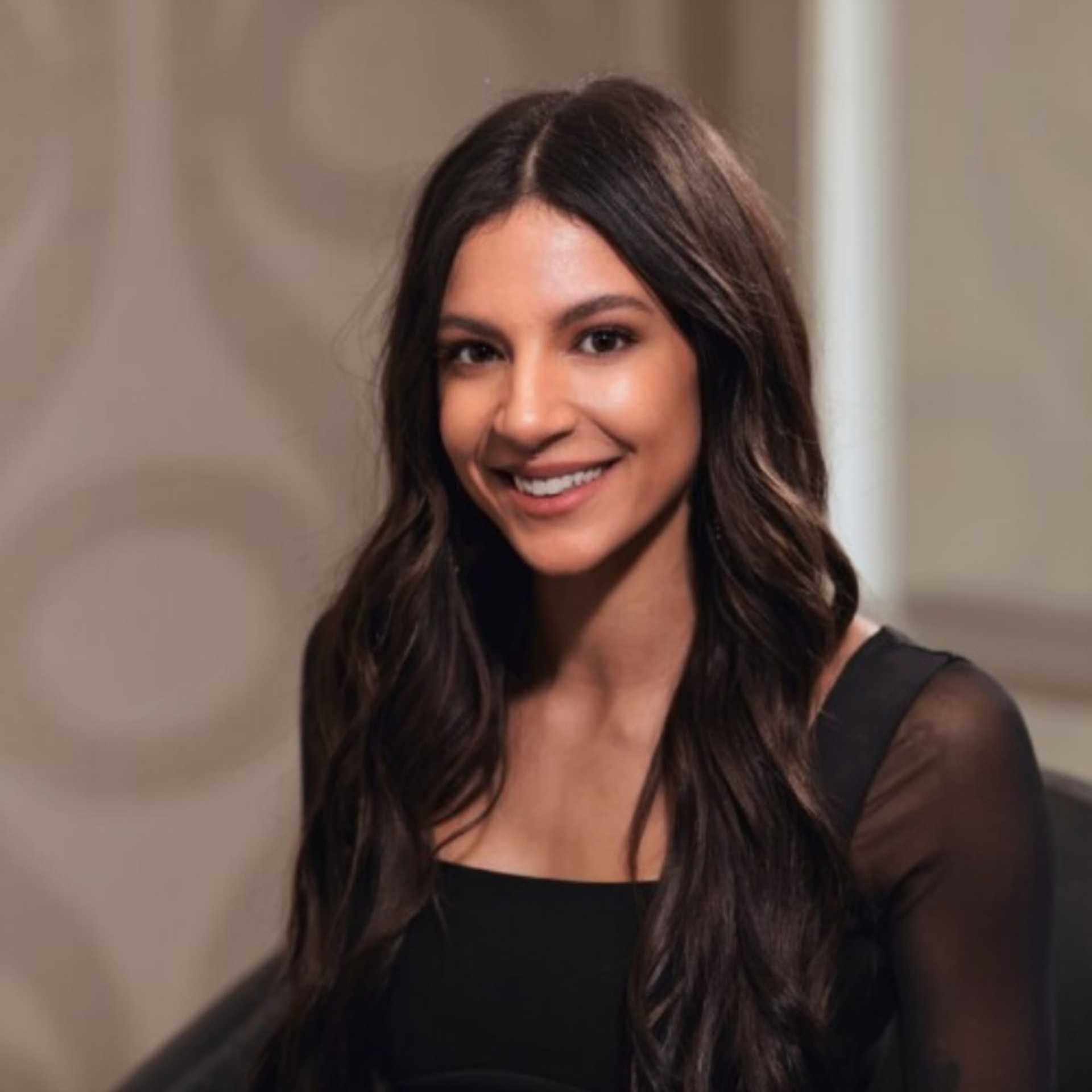 Portrait of Amara Carrington, a professional stylist at Studio Seven, showcasing their expertise and style.