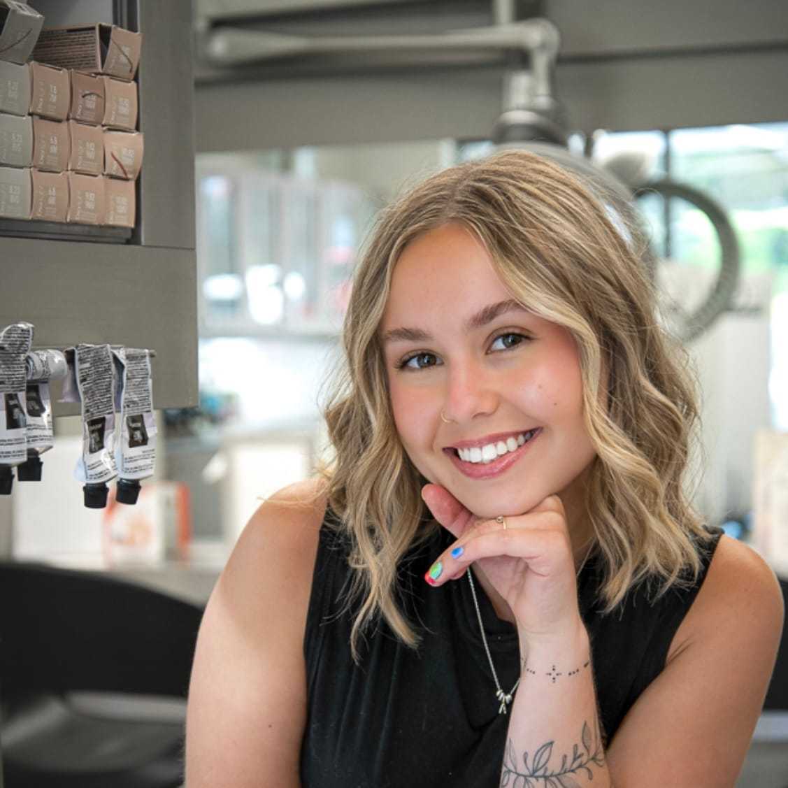 Portrait of Macy Comfort, a professional stylist at Studio Seven, showcasing their expertise and style.
