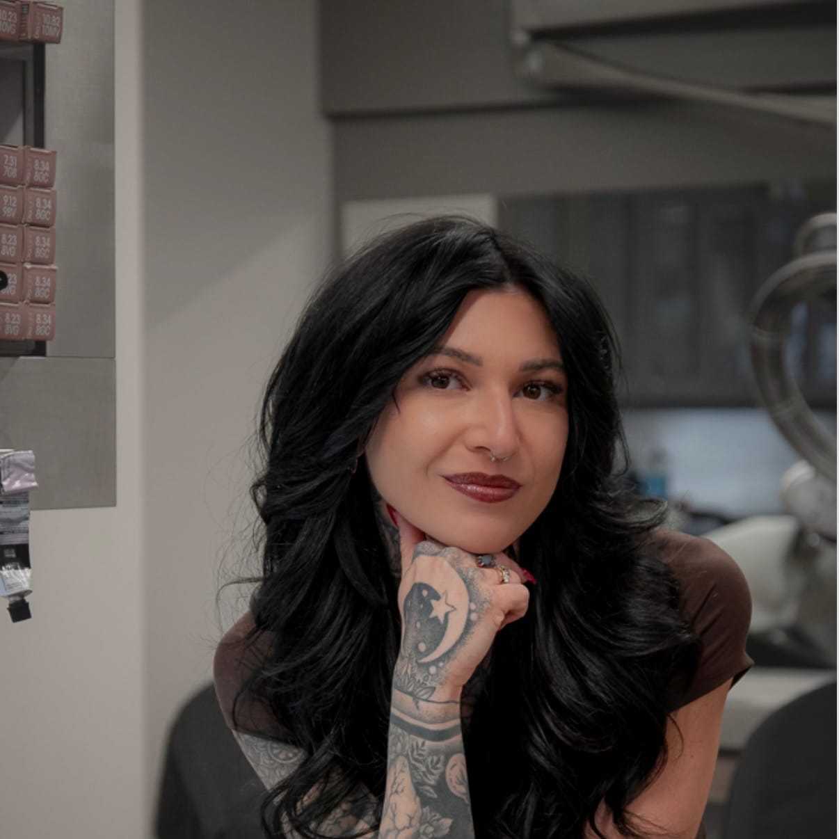 Portrait of Logen Claude, a professional stylist at Studio Seven, showcasing their expertise and style.
