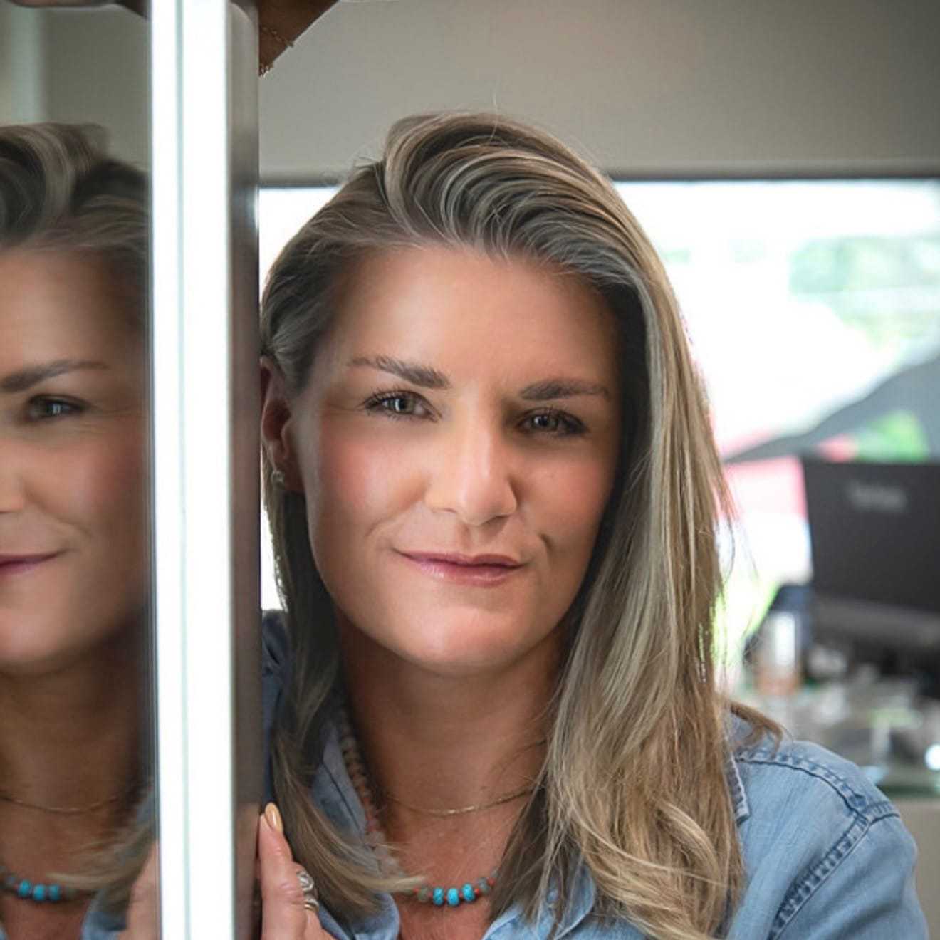 Portrait of Amy Neel, a professional stylist at Studio Seven, showcasing their expertise and style.