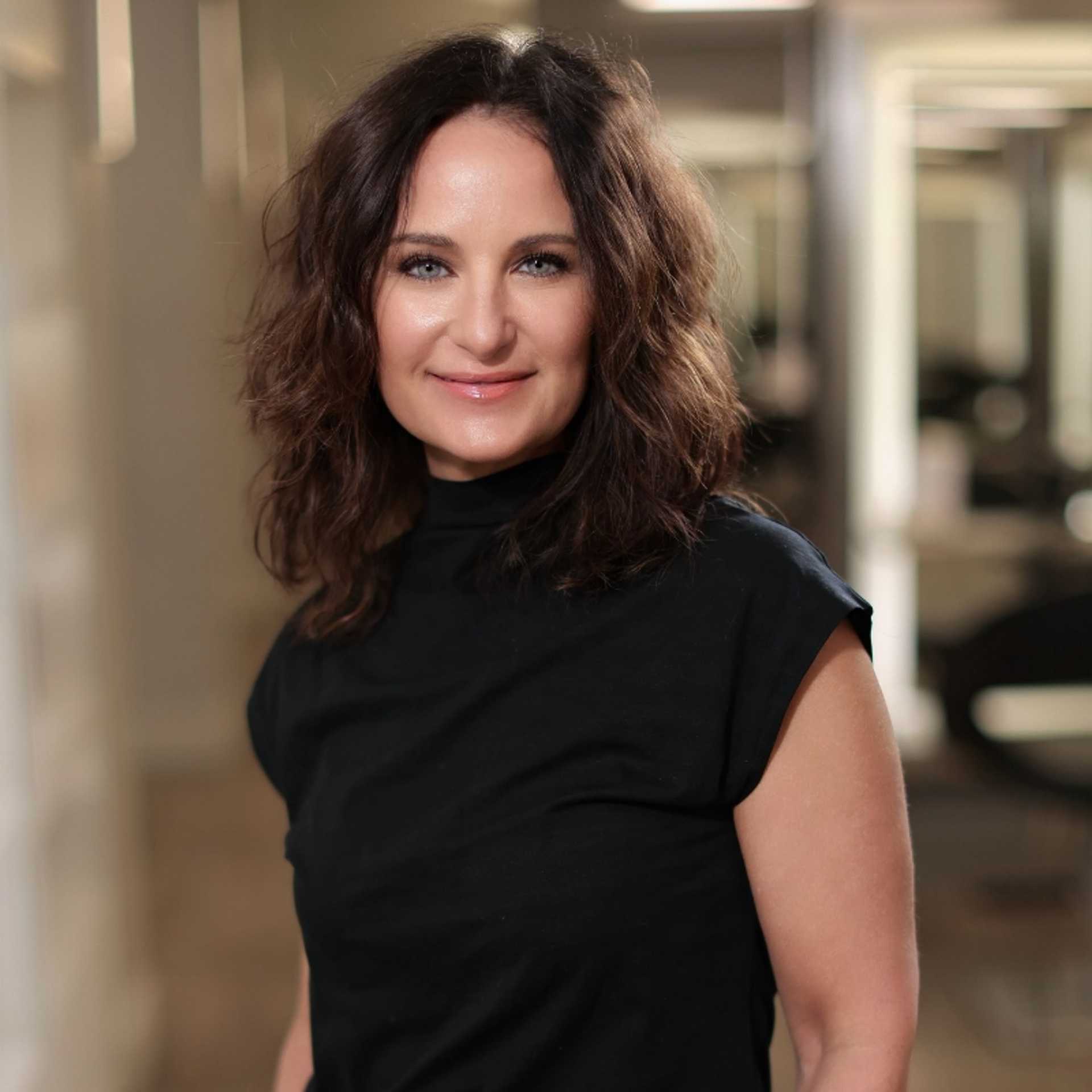 Portrait of Alisha DeLuca, a professional stylist at Studio Seven, showcasing their expertise and style.