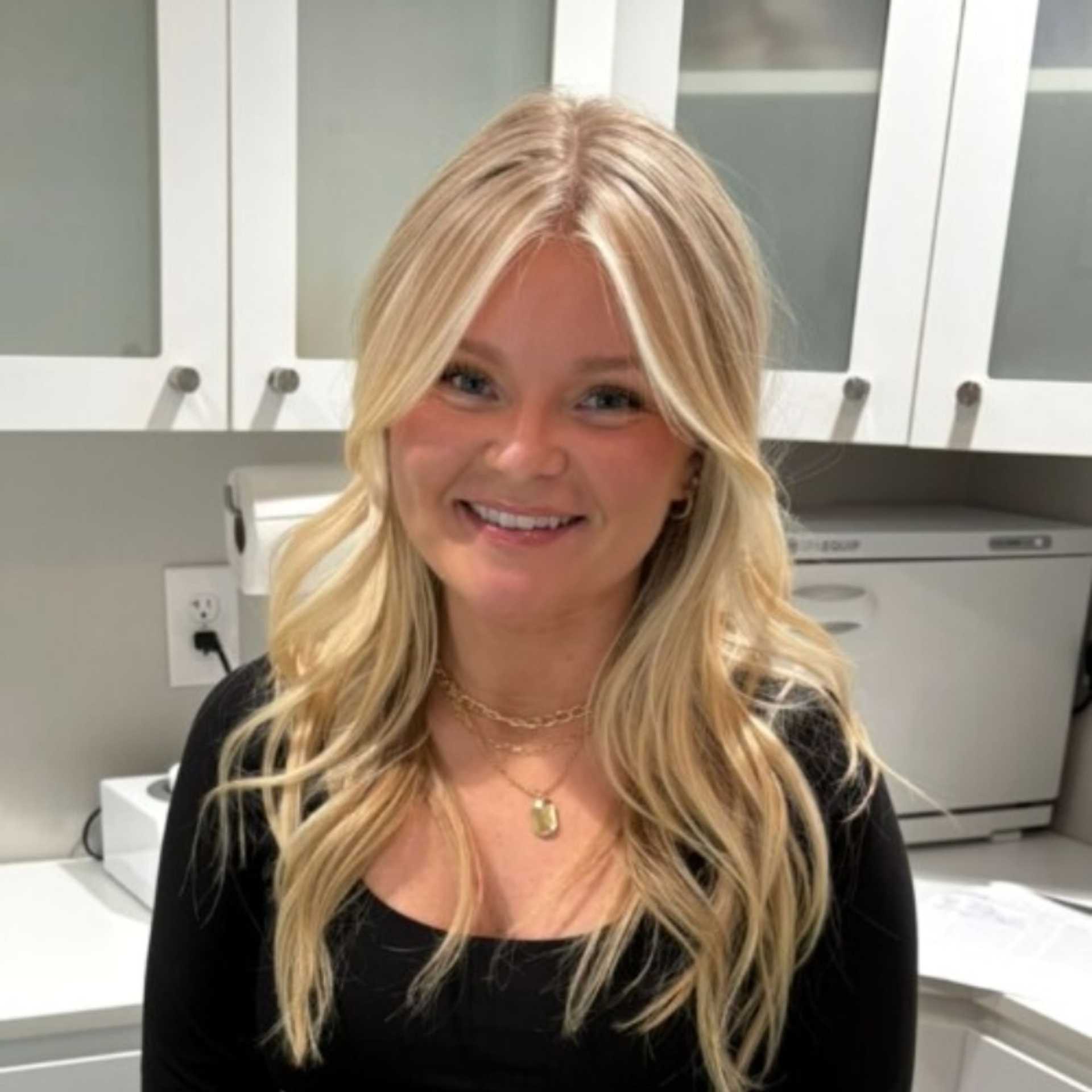 Portrait of Shelby Henry, a professional stylist at Studio Seven, showcasing their expertise and style.