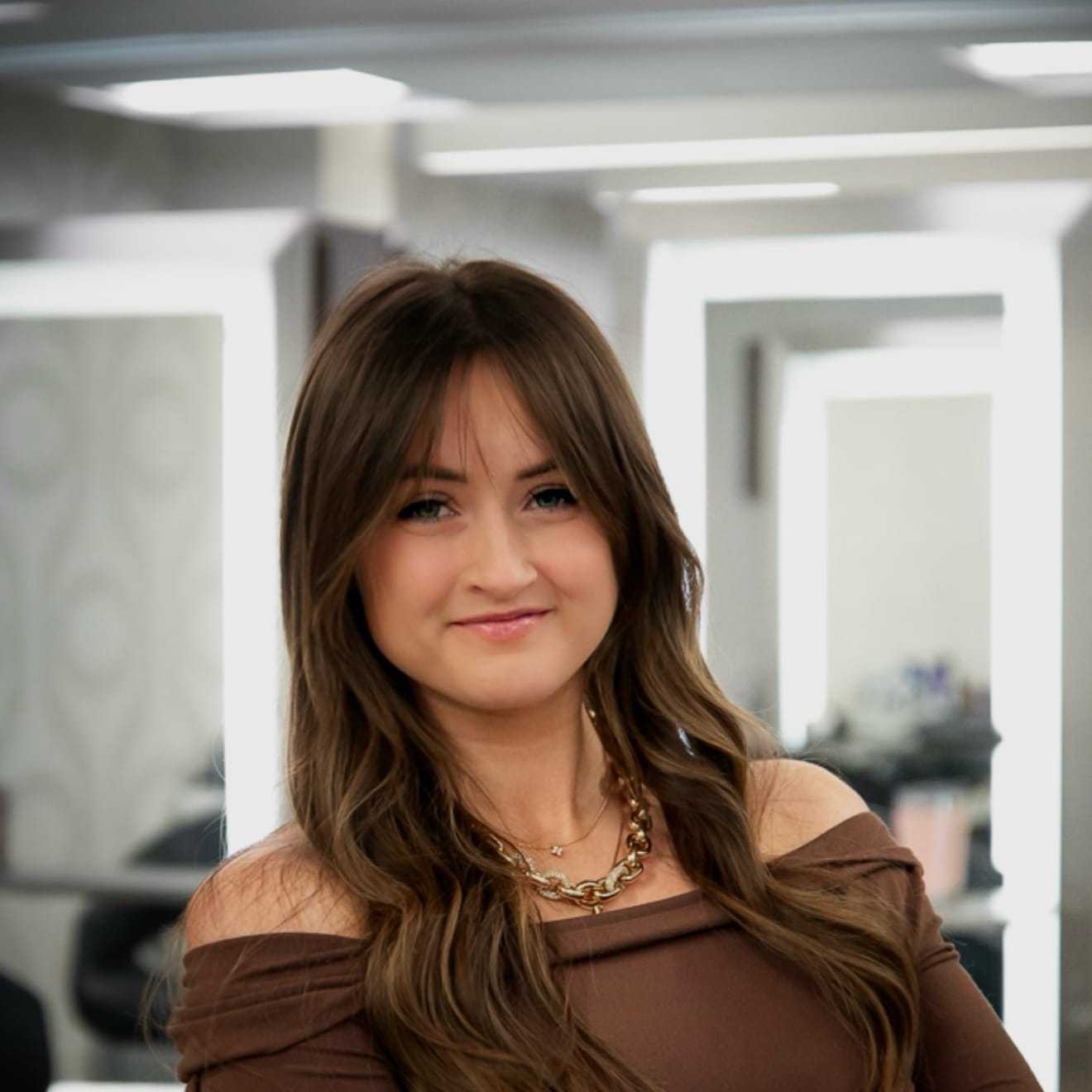 Portrait of Darianne James, a professional stylist at Studio Seven, showcasing their expertise and style.