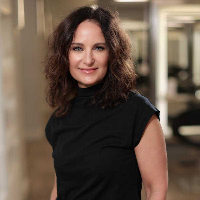 Portrait of Alisha DeLuca, a professional stylist at Studio Seven, showcasing their expertise and style.