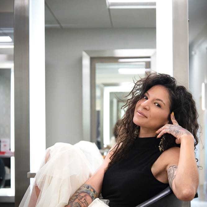 Portrait of Amara Carrington, a professional stylist at Studio Seven, showcasing their expertise and style.