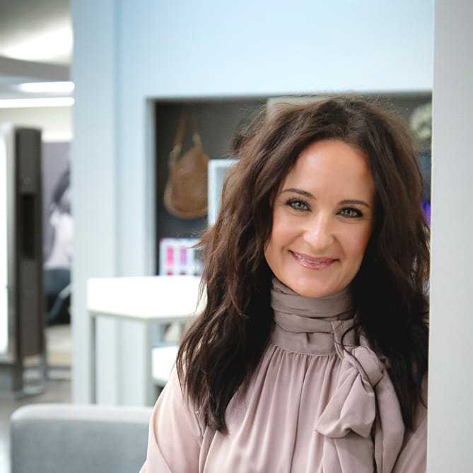 Portrait of Alisha DeLuca, a professional stylist at Studio Seven, showcasing their expertise and style.
