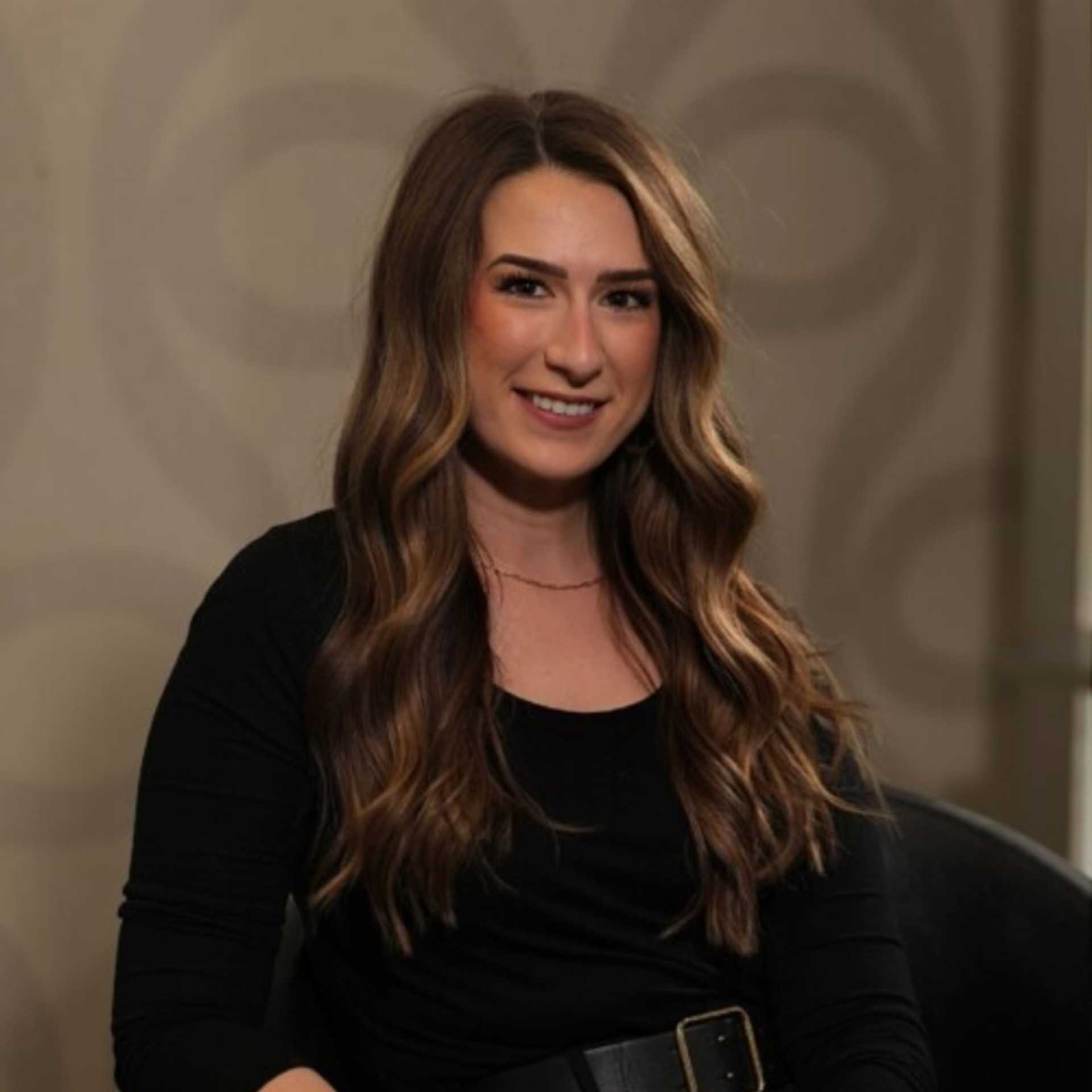 Portrait of Emily Belleville, a professional stylist at Studio Seven, showcasing their expertise and style.