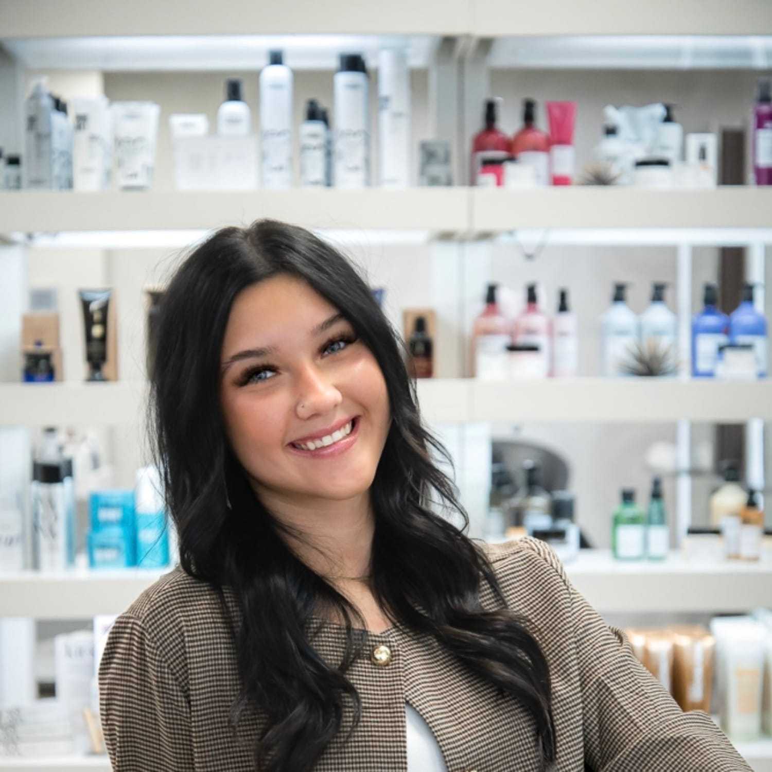 Portrait of Norah Carnahan, a professional stylist at Studio Seven, showcasing their expertise and style.